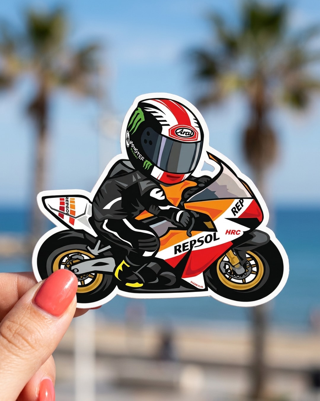 Pegatina Piloto de Motociclismo Repsol en Caricatura sostenida en la mano, a tamaño real