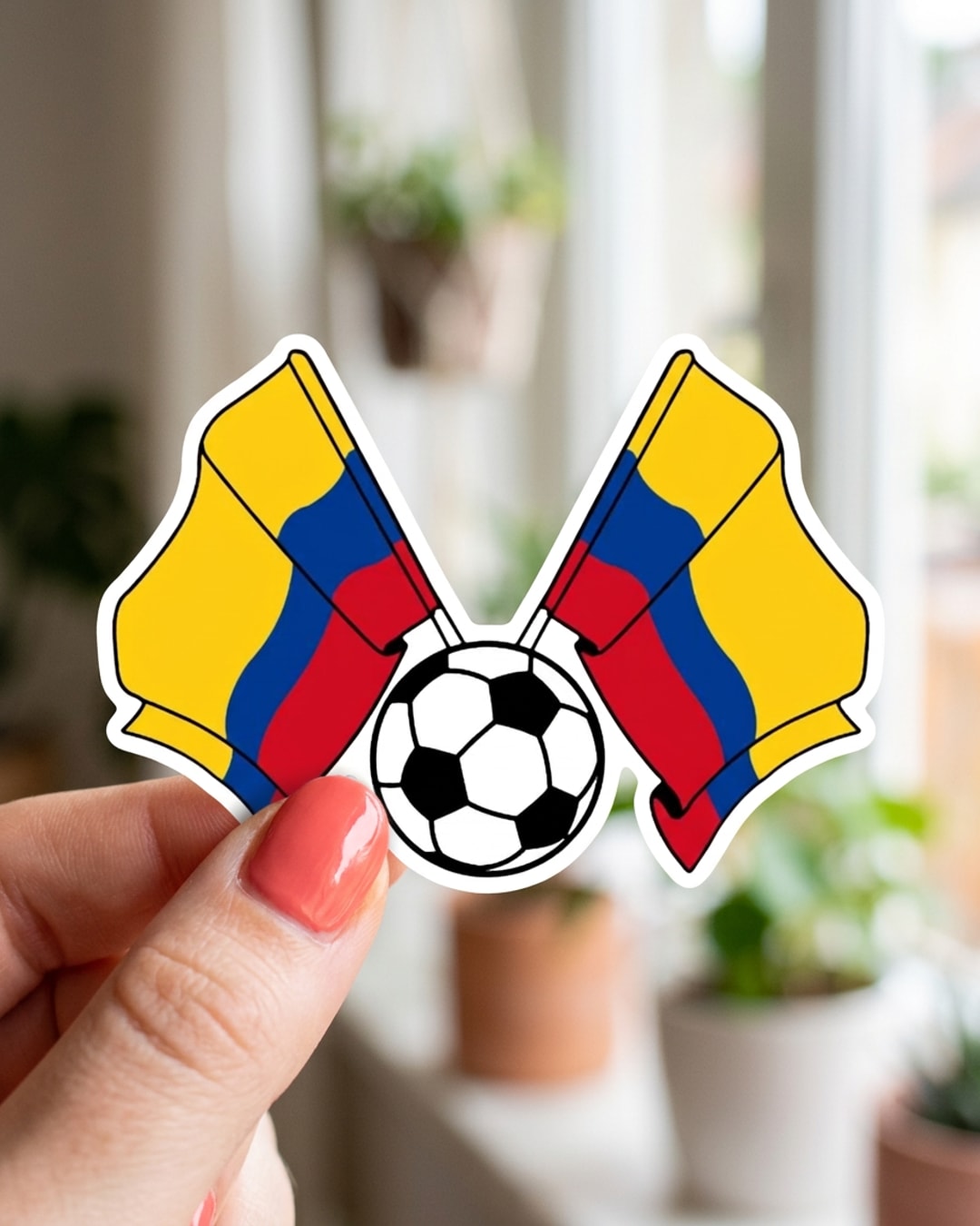 Pegatina Banderas de Colombia y balón de fútbol sostenida en la mano, a tamaño real