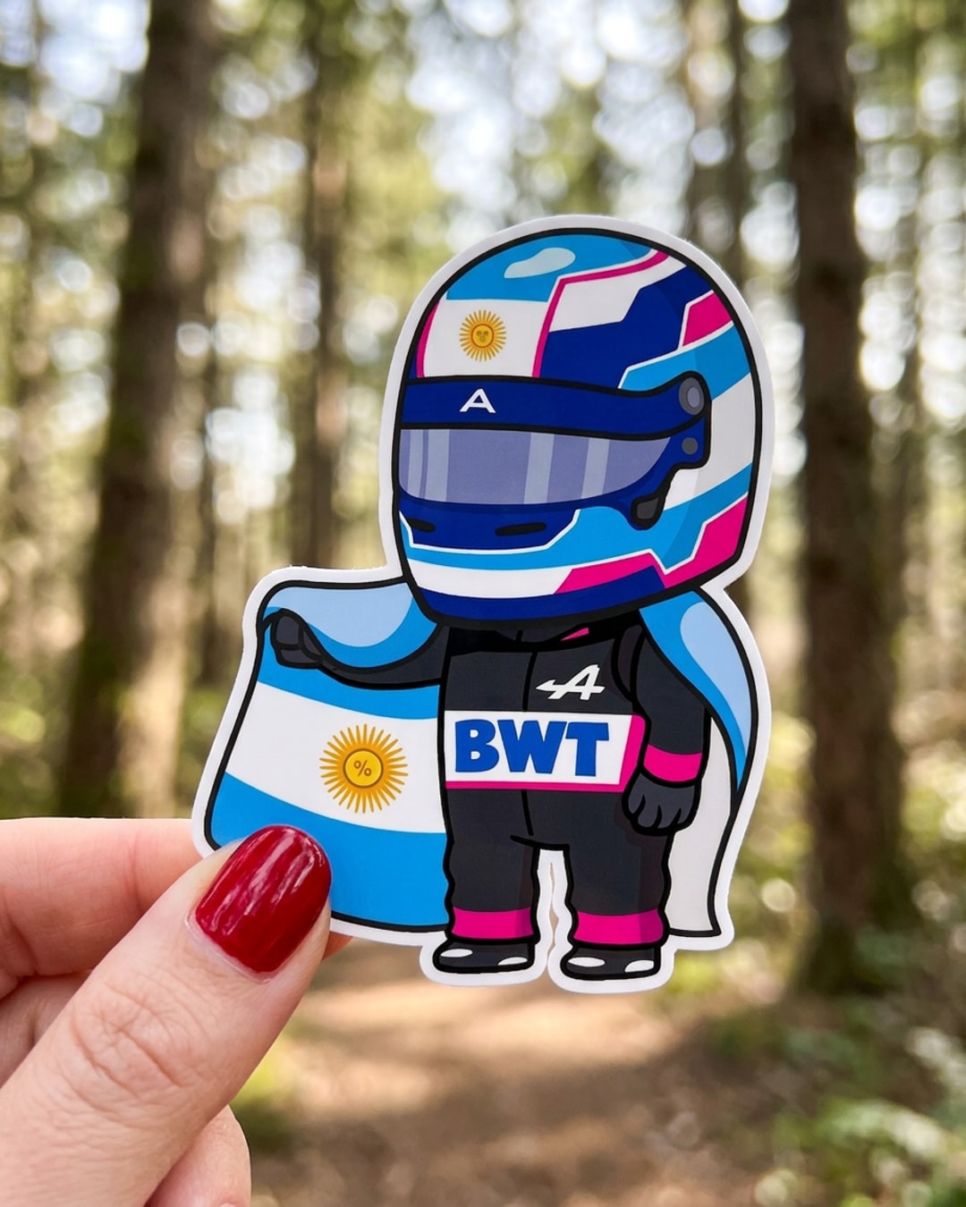 Pegatina Piloto de F1 Argentino de Alpine y BWT sostenida en la mano, a tamaño real
